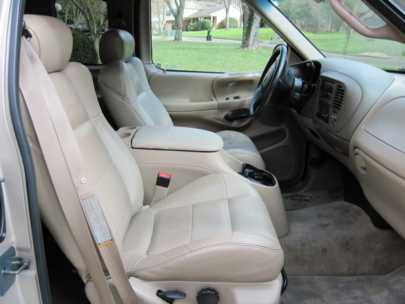 Tan leather front seats and center console of a 1997 Ford F-150
