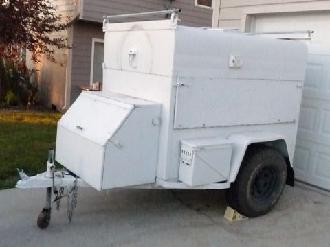 2006 Ford E350 - This white utility trailer features several storage boxes and a single axle, seen parked in a driveway.