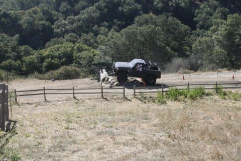 1989 Ford Bronco - An off-road truck navigates a rocky obstacle course, kicking up dust.