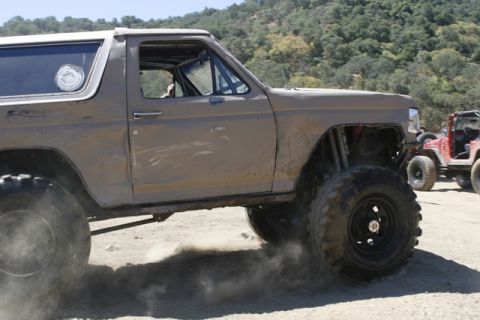 1989 Ford Bronco - Modified 1989 Ford Bronco seen off-roading with a Jeep in the background.