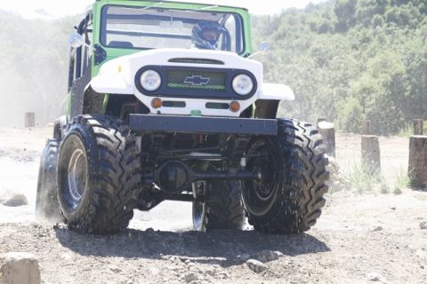 1989 Ford Bronco - This heavily modified off-road vehicle features oversized tires and a prominent Chevrolet grille, suggesting a custom build rather than a s…