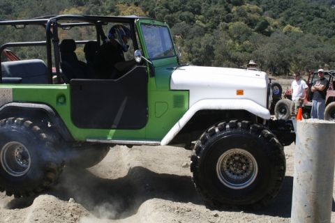 1989 Ford Bronco - This modified Toyota Land Cruiser FJ40 is navigating a challenging off-road course.