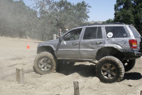 1989 Ford Bronco - This Jeep Grand Cherokee is equipped for terrain, a lifted suspension and large off-road tires as it tackles a sandy obstacle course.