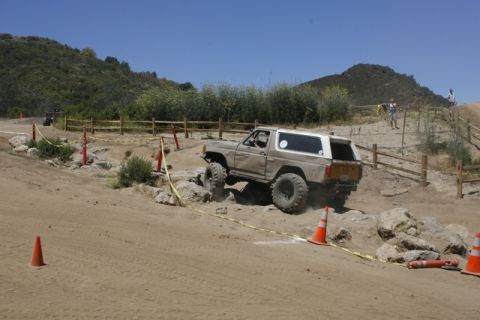 1989 Ford Bronco - An off-road SUV tackles a challenging course with large tires and lifted suspension.