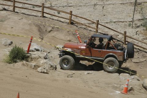 1989 Ford Bronco - A Jeep CJ-7 tackles a rocky trail during an off-road event.