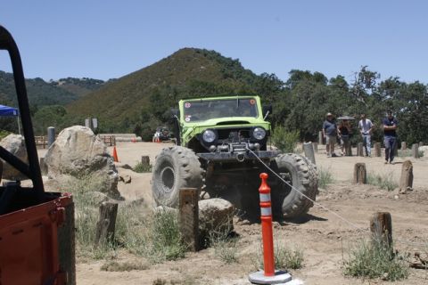 1989 Ford Bronco - Off-road vehicle navigating a course with spectators in the background.