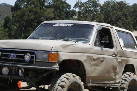 1989 Ford Bronco - This 1989 Ford Bronco shows signs of off-road use with dents and large tires, a "Santa Cruz" sticker on its windshield.