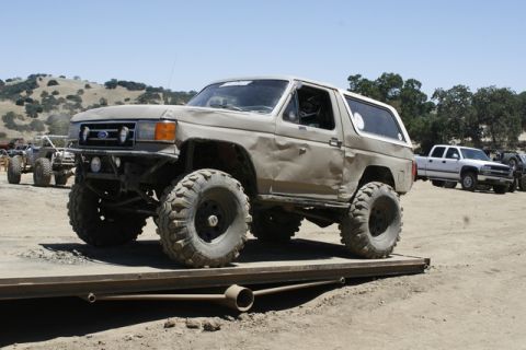 1989 Ford Bronco - Modified 1989 Ford Bronco on a trailer, with other vehicles in the background.