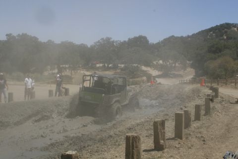 1989 Ford Bronco - Off-road vehicle tackles a challenging mud course during an event.