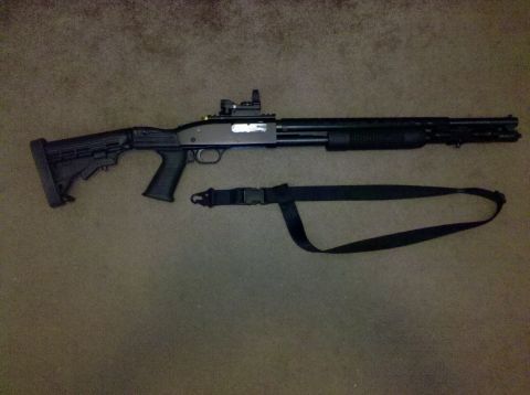 2001 Ford F-150 - A tactical shotgun is displayed with its adjustable stock, red dot optic, and a sling attached.