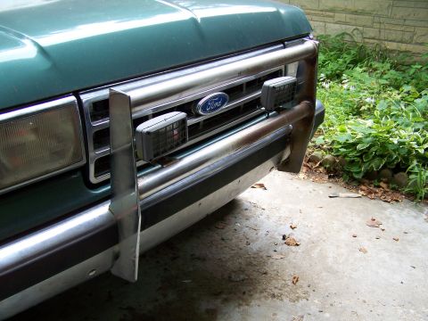 1989 Ford Bronco - Front view of a green 1989 Ford Bronco, its chrome bumper and grille.