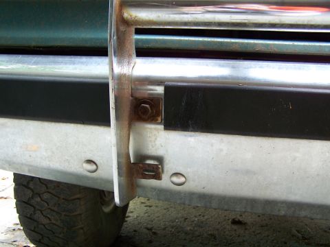 1989 Ford Bronco - Detail shot of a vehicle's front end, focusing on the bumper and brush guard assembly.