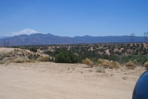 1995 Ford Bronco - Desert scenery with mountains in the distance and power lines on the right side.