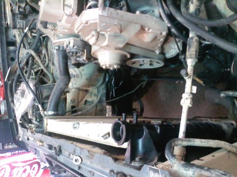 1990 Ford Bronco - Close-up view of the engine bay, focusing on the radiator and associated plumbing and wiring.