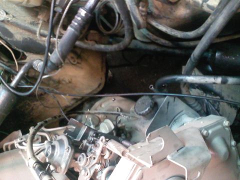 1990 Ford Bronco - Close-up view of an engine bay, showing a carburetor and various hoses and wires.