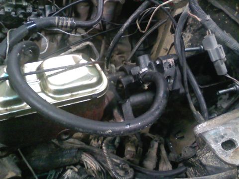 1990 Ford Bronco - Close-up of engine bay components, including the brake master cylinder and associated plumbing.