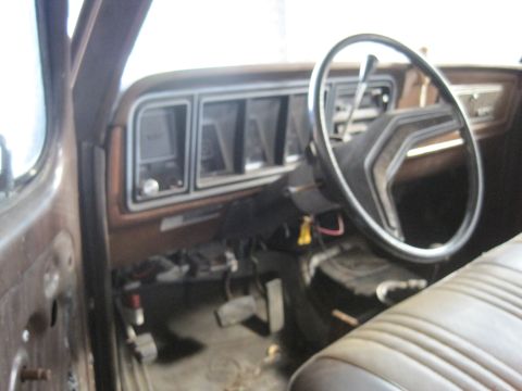 1979 Ford Bronco - The interior of a 1979 Ford Bronco, with a focus on the dashboard and steering wheel.