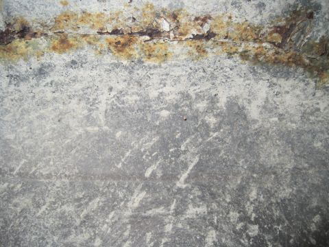 1979 Ford Bronco - Close-up of a heavily rusted metal panel, possibly from a vehicle's undercarriage, with a Supermotors watermark visible.