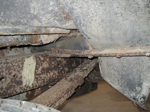 1979 Ford Bronco - Undercarriage view showing significant rust on the leaf springs and frame.