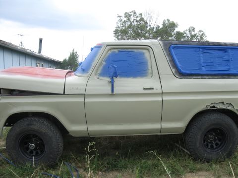 1978 Ford Bronco - This 1978 Ford Bronco is being prepped for paint, with windows taped and hood sectioned in red.