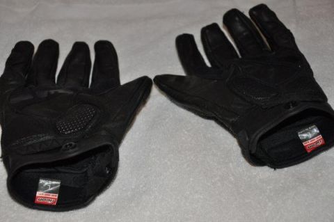 2008 Honda CBR-RR - Black leather motorcycle gloves with textured palms and interior ICON branding are shown against a light-colored background.
