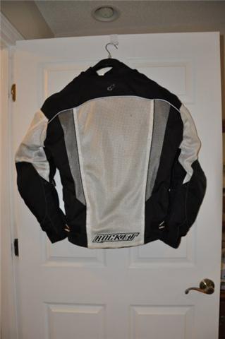 2008 Honda CBR-RR - Motorcycle jacket with "ROCKER" logo hanging on a door.