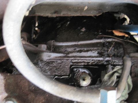 1979 Ford Bronco - Engine oil pan area with hoses and a rag visible.