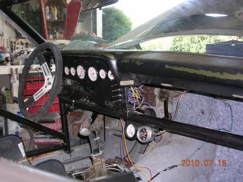 1972 Ford Ranchero - The interior of a car shows a dashboard with gauges and exposed wiring, suggesting it is undergoing modifications or has undergone modifica…