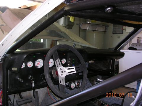 1972 Ford Ranchero - The interior of a modified vehicle features a roll cage, custom dashboard with multiple gauges, and a racing steering wheel.