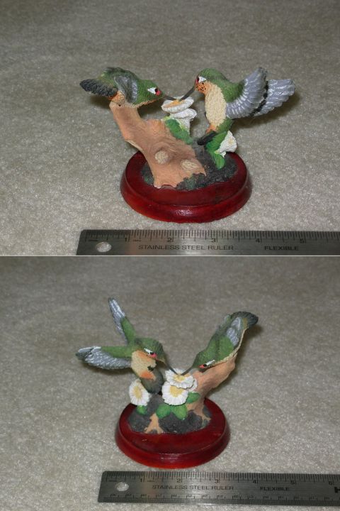 2004 Land Rover Land Rover - Figurines of hummingbirds feeding on flowers, displayed on a red base.