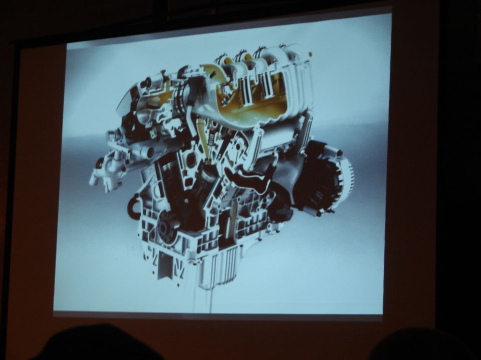 Photo of a projected slide showing a cutaway rendering of a V6 engine