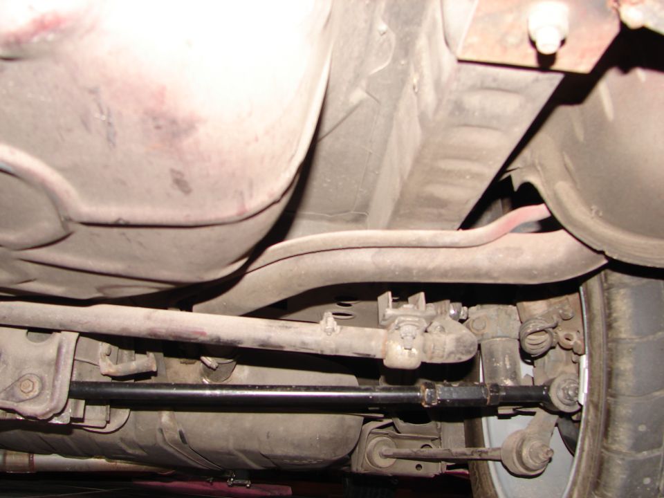 Underside of a vehicle showing suspension components and fuel tank