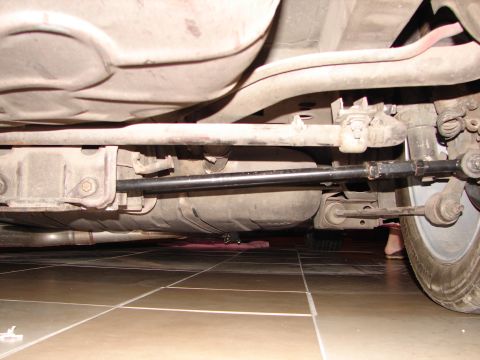 1992 Ford Taurus - The underside of a vehicle is shown, focusing on suspension components and the fuel tank.