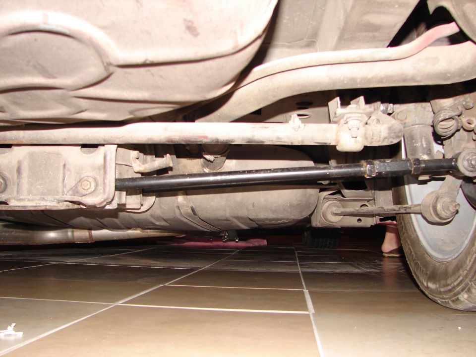 Underbody view of car suspension and fuel tank