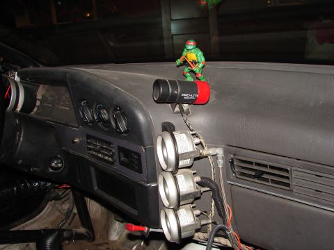 1992 Ford Taurus - Aftermarket gauges and a toy adorn the dashboard of this vehicle's interior.