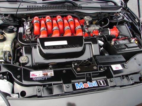 1992 Ford Taurus - Engine bay details with prominent V8 32 Valve branding and Mobil 1 sticker.