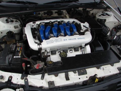 1992 Ford Taurus - The engine bay of a 1992 Ford Taurus SHO, the distinctive SHO 24 Valve DOHC branding on the intake manifold.