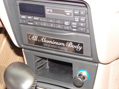 1992 Ford Taurus - Interior view of a car's dashboard, the radio and a special edition plaque.
