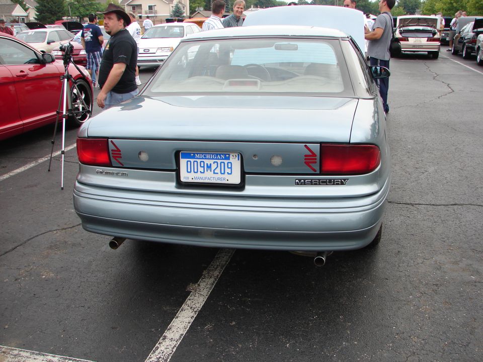 Light blue Mercury Sable sedan rear view, Michigan license plate 009M209, dual exhaust pipes