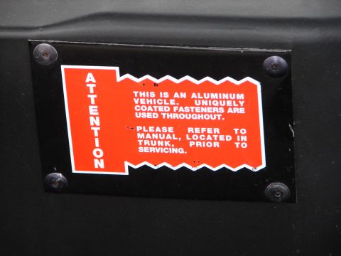1992 Ford Taurus - Sticker warns about unique fasteners used on an aluminum vehicle.