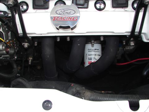 1992 Ford Taurus - Close-up of engine components, including a Ford Racing oil cap and exhaust manifold.