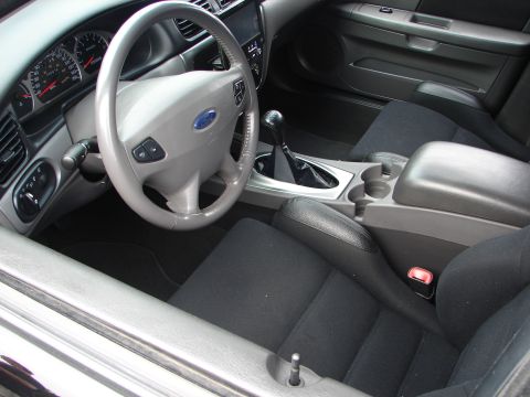 1992 Ford Taurus - The interior of a car is shown, the dashboard, steering wheel, and front seats.