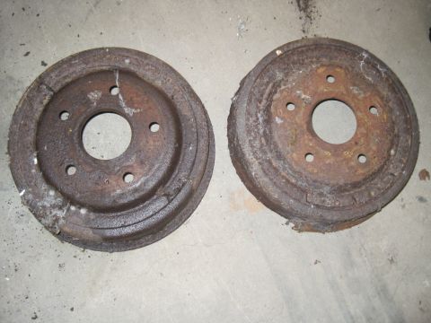 1979 Ford Bronco - Pair of old brake drums, likely needing replacement.