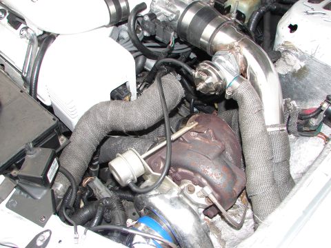 1992 Ford Taurus - Engine bay detail showing a turbocharger setup with associated plumbing and components.