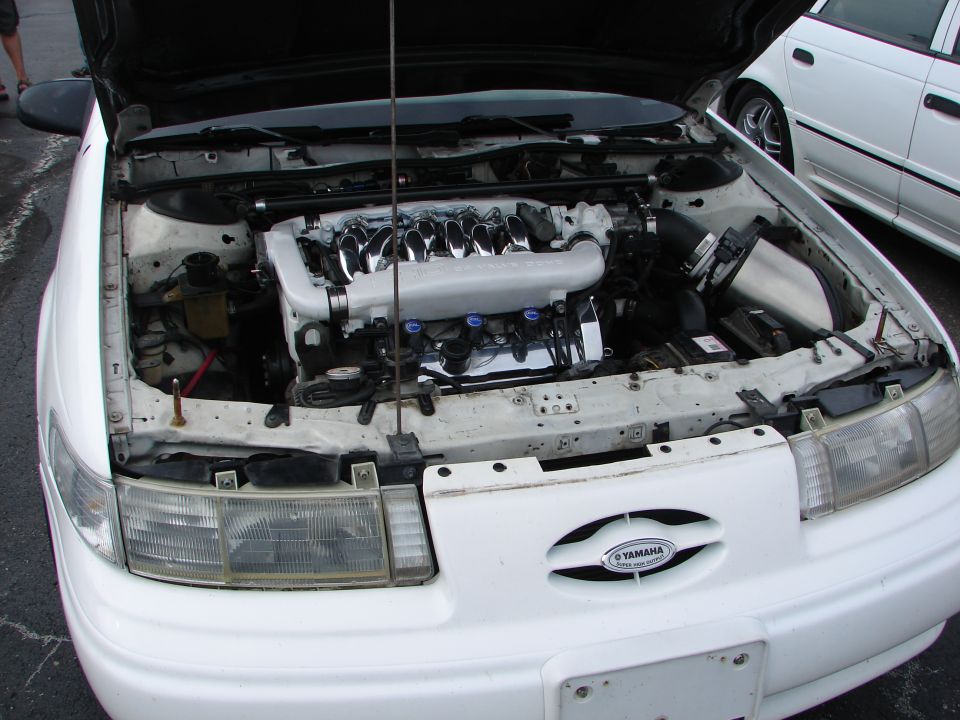 1992 Ford Taurus engine bay with custom intake and Yamaha badge on grille
