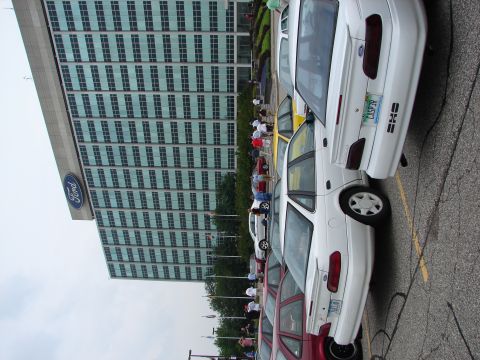 1992 Ford Taurus - A line of Ford Taurus sedans are parked in front of the Ford building, likely at a convention.