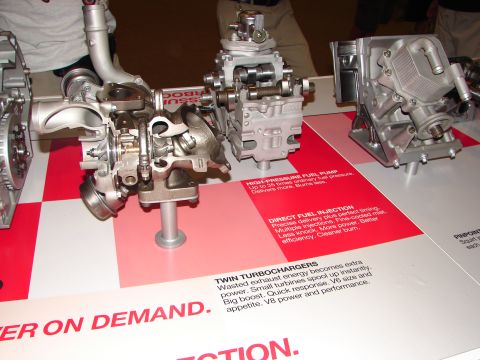 1992 Ford Taurus - Display shows cutaway engine components including twin turbochargers and a high-pressure fuel pump.