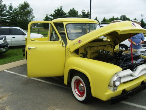 2007 Ford Mustang - Yellow 1956 Ford F-series pickup truck shown with its hood open and driver's door ajar.