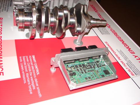 1992 Ford Taurus - A display an engine crankshaft and an electronic control unit with text describing its functions.