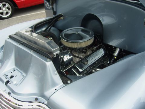 2007 Ford Mustang - Classic Chevrolet engine bay with chrome accents and aftermarket radiator.